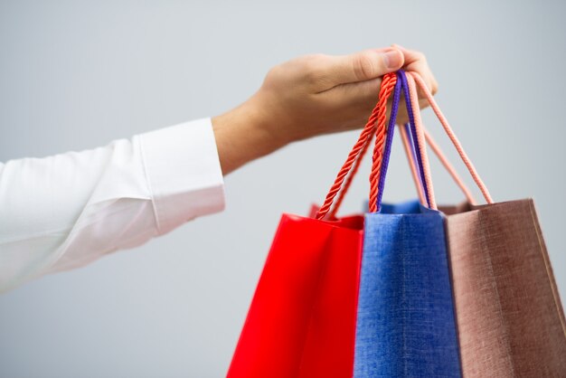 Closeup of man holding shopping bags