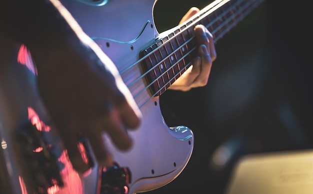 Free photo closeup of a man playing the bass guitar