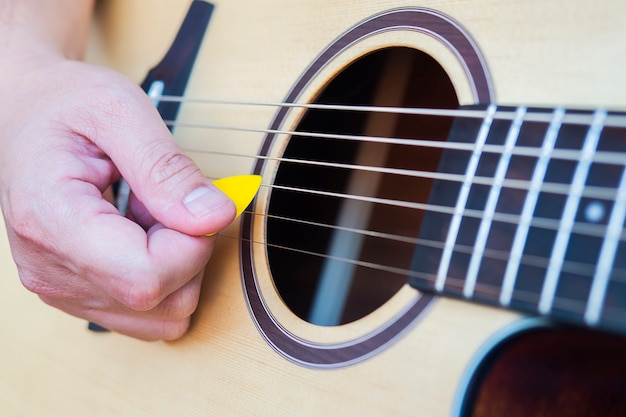 Closeup of man playing guitar