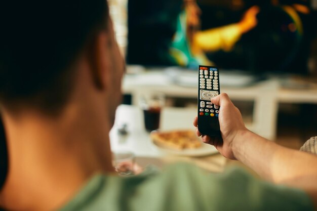 Closeup of man watching TV at home