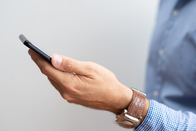 Closeup of manager holding smartphone