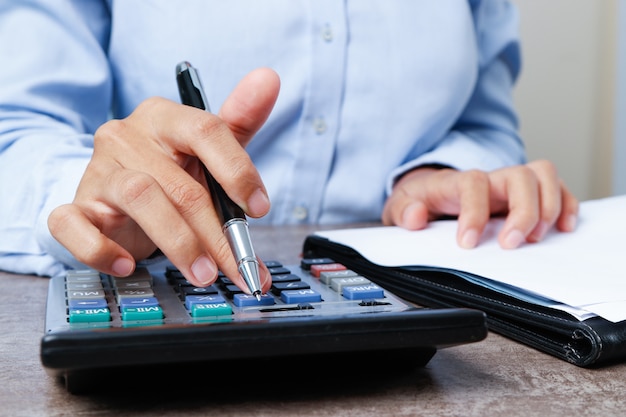 Closeup of marketing expert using calculator