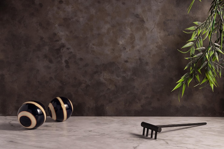 Free Photo closeup of a mini wooden rake with striped balls on the white marble surface