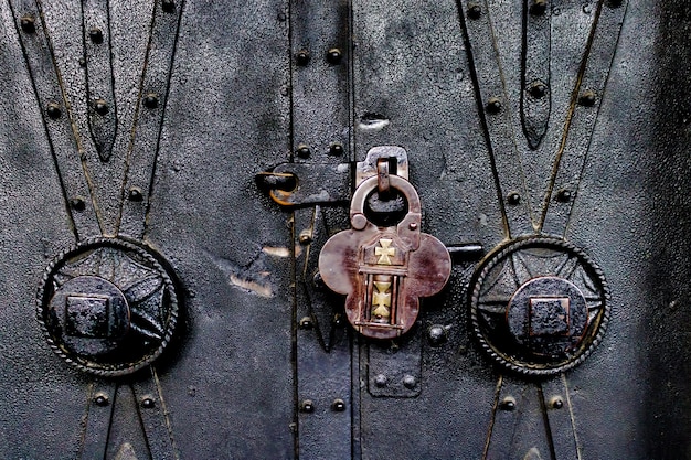 Closeup of an old padlock on an old ornate church door