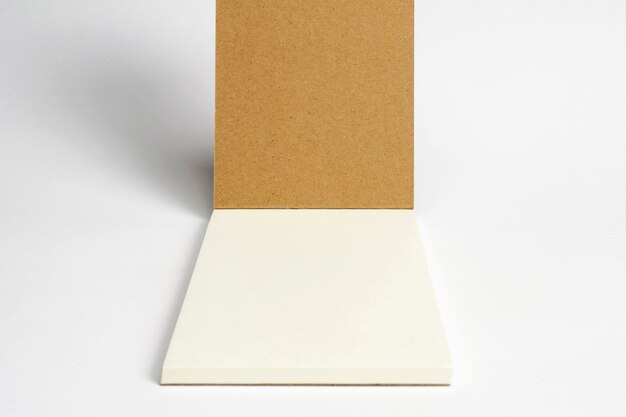 Closeup of opened diary with cardboard hardcover and blank pages isolated on white.