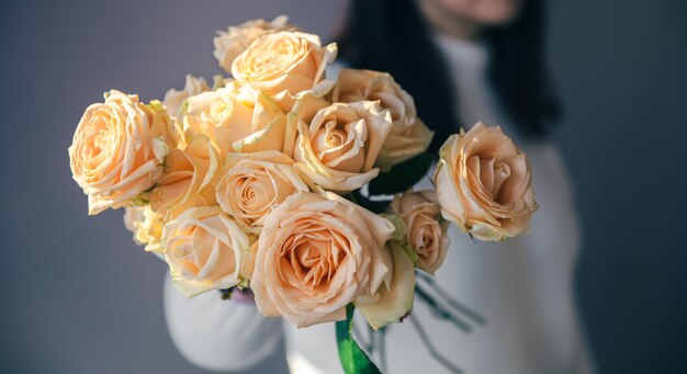 Closeup of orange roses in female hands