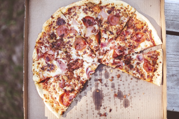 Closeup overhead shot of a delicious pizza in an outdoor environment