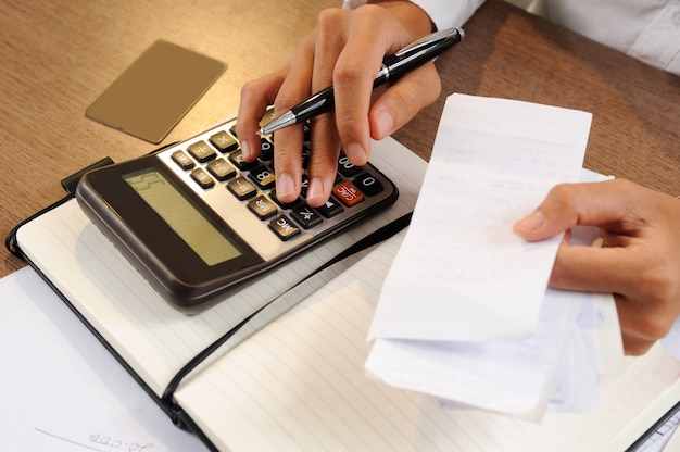 Free photo closeup of person holding bills and calculating them