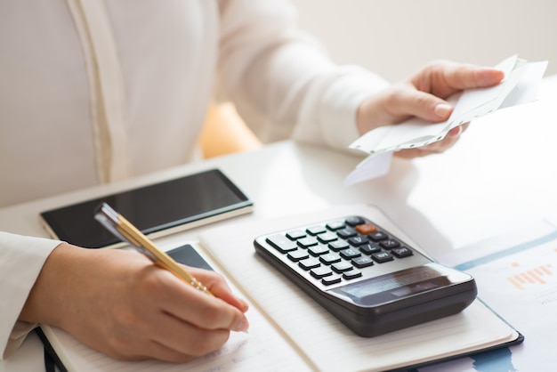 Free photo closeup of person holding bills and calculating them