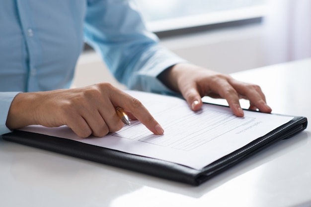 Closeup of person reading and studying document