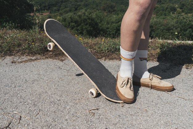 Closeup of a person skateboarding in a park under the sunlight with a blurry