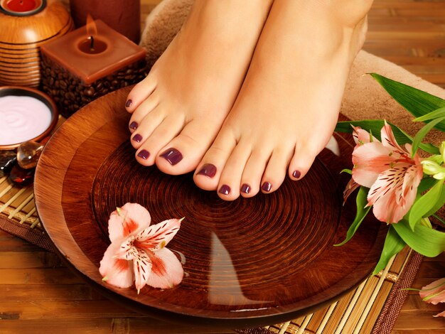 Closeup photo of a female feet at spa salon on pedicure procedure.