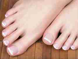 Foto gratuita foto del primo piano di un piede femminile con il pedicure francese bianco sulle unghie