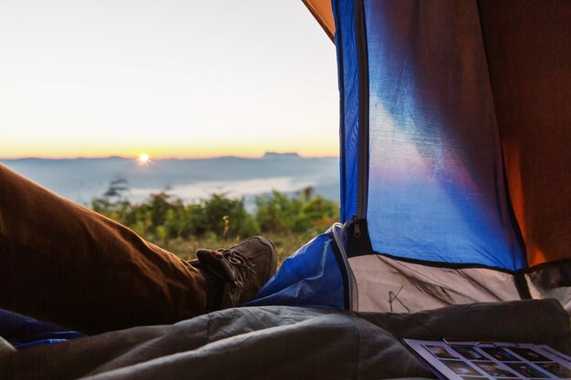 Closeup photo of legs in tent. Travel trekking expedition concept