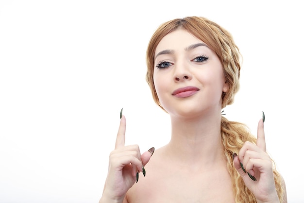 Closeup photo of young blonde point her fingers up and looking at the camera