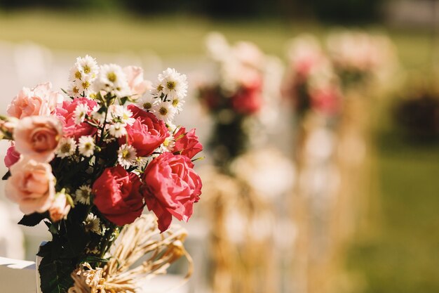 Closeup of pink roses put in a bouquet tied with a chair