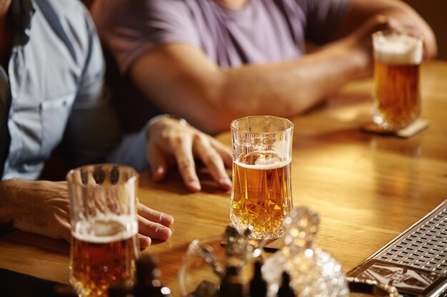 Closeup of pints of beer in bar