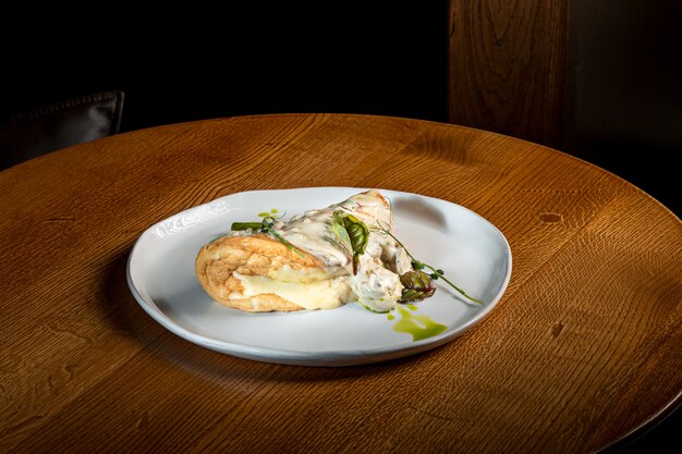 The closeup of a plate with a typical tortilla de patatas, spanish omelet, on a set table