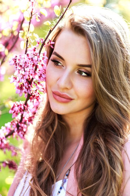 Closeup portrait amazing cheerful young woman with long hair in sunlight outdoor