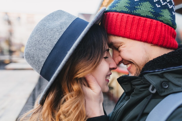 Closeup portrait amazing couple in love enjoying time together on street. True lovely emotions, brightful feelings, happiness, christmas time, falling in love.