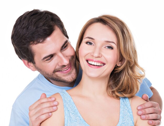 Closeup portrait of attractive smiling couple isolated