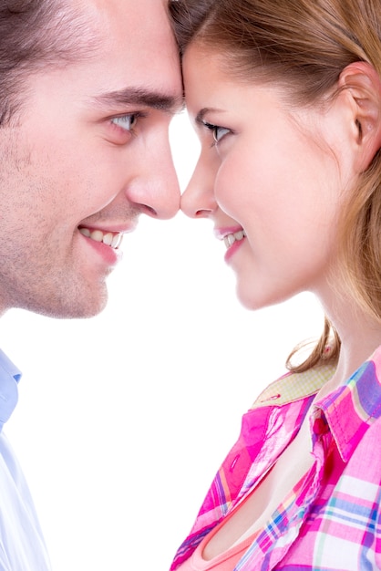 Free photo closeup portrait of beautiful smiling couple looking at each other isolated