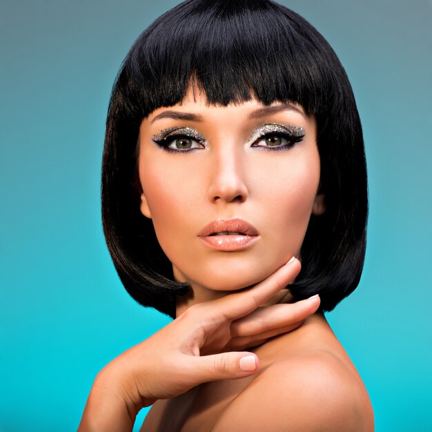 Closeup portrait of  beautiful woman with bob hairstyle. Fashion model face with creative makeup