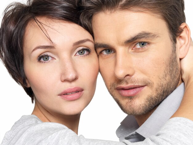 Closeup portrait of  beautiful young  couple . Attractive man and woman looking at camera