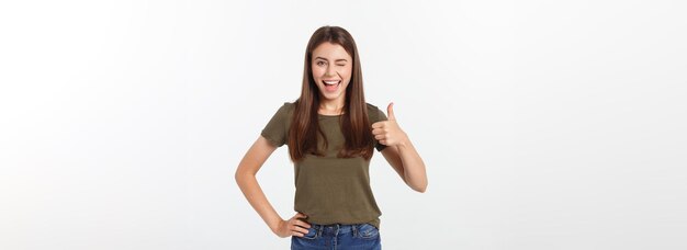 親指を示す美しい若い女性のポートレート、クローズ アップ ホワイト バック グラウンドを分離します。