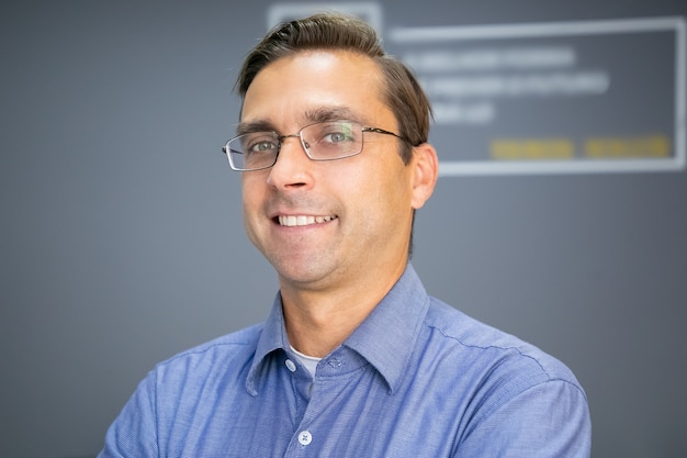 Closeup portrait of Caucasian happy teacher in glasses