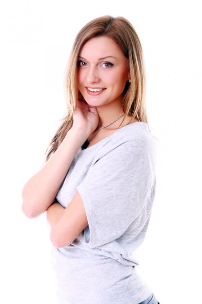 Closeup portrait of cute young girl smiling against white background