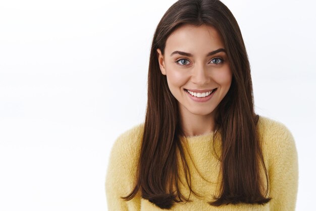 Closeup portrait feminine gorgeous young brunette woman with beaming white smile looking camera happy grinning concept of beautiful people and skincare products promo white background