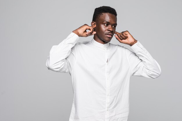 Closeup portrait of handsome man covering his ears, headache from loud noise, isolated on white background