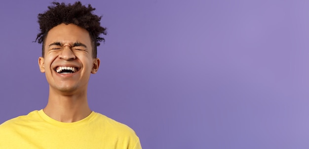 Free photo closeup portrait of happy carefree young guy laughing loud chuckling over hilarious joke bending bac