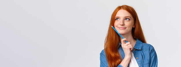 Free photo closeup portrait inspired dreamy and talented cute redhead woman thinking what draw holding colored