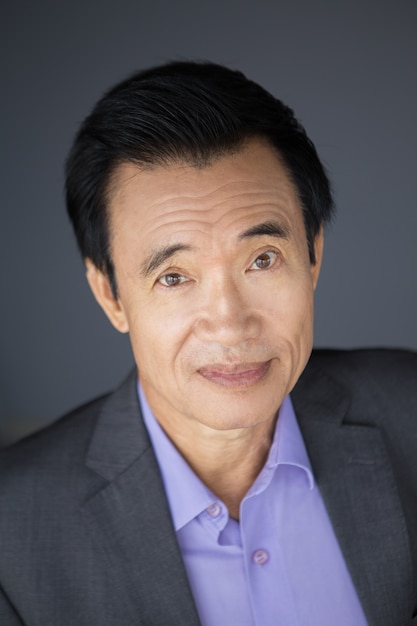 Closeup Portrait of Middle-aged Asian Businessman