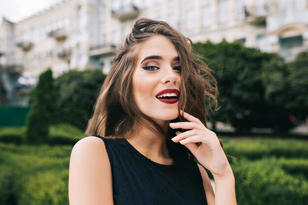 Closeup portrait of pretty girl with long curly hair