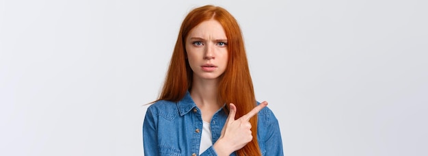 Free photo closeup portrait seriouslooking skeptical and displeased angry bothered redhead girlfriend waiting e