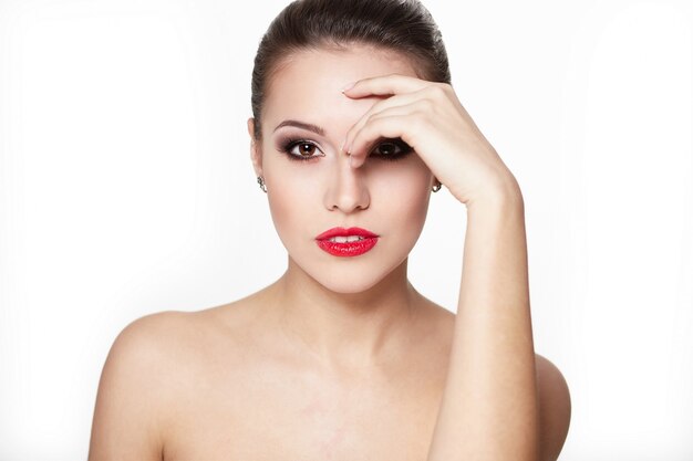 closeup portrait of sexy caucasian young woman model with glamour red lips,bright makeup, eye arrow makeup, purity complexion. Perfect clean skin.