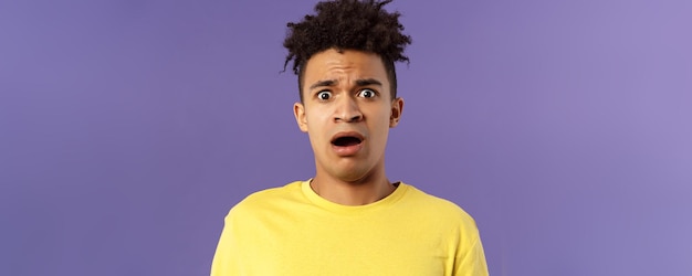 Closeup portrait of shocked alarmed young man gasping open mouth scared and frightened staring camer