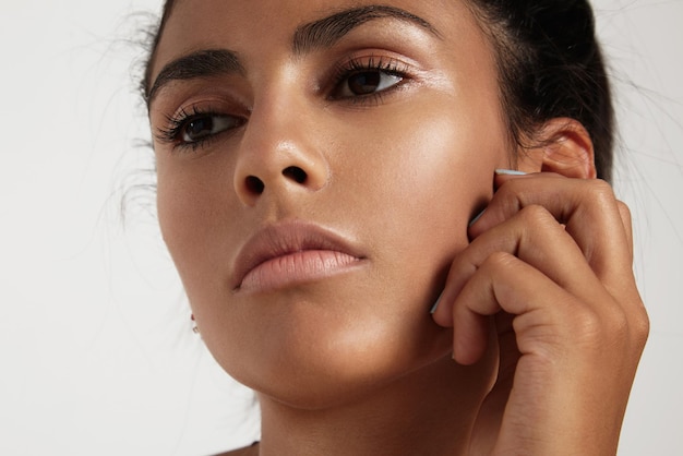 Closeup portrait of spanish woman with ideal skin watching aside