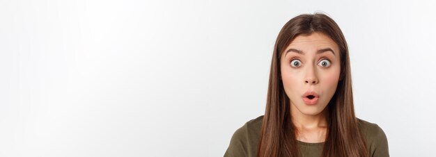 Closeup portrait of surprised beautiful girl holding her head in amazement and openmouthed over whit