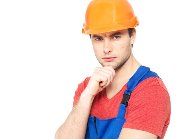 Closeup portrait of thinking handyman in uniform isolated on white