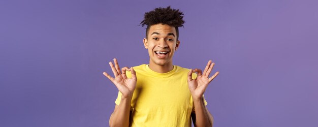 Closeup portrait of upbeat relaxed young hipster guy with dreads assuring all good everything be oka