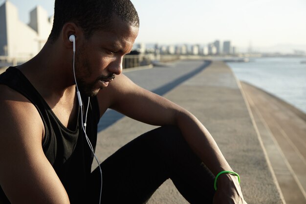 Closeup portrait of young bearded man listening to music