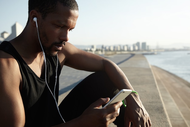 Closeup portrait of young bearded man listening to music