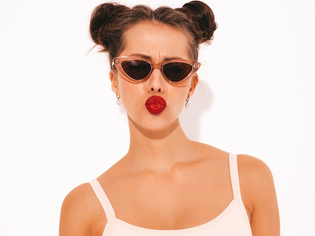 Closeup portrait of young beautiful sexy hipster woman with red lips in sunglasses.