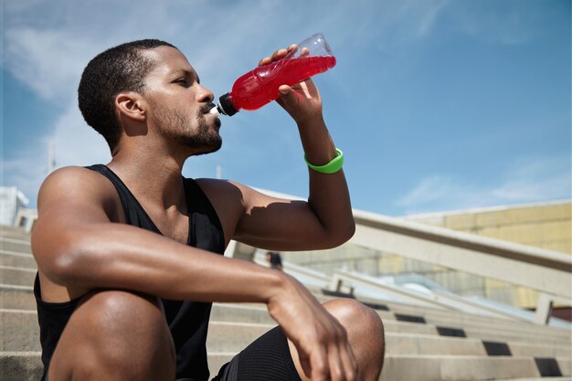 Closeup portrait of young man hydrating himself