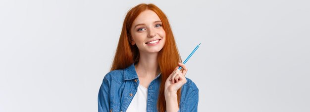 Free photo closeup portrant attractive talented redhead girl got inspired want draw something holding colored p