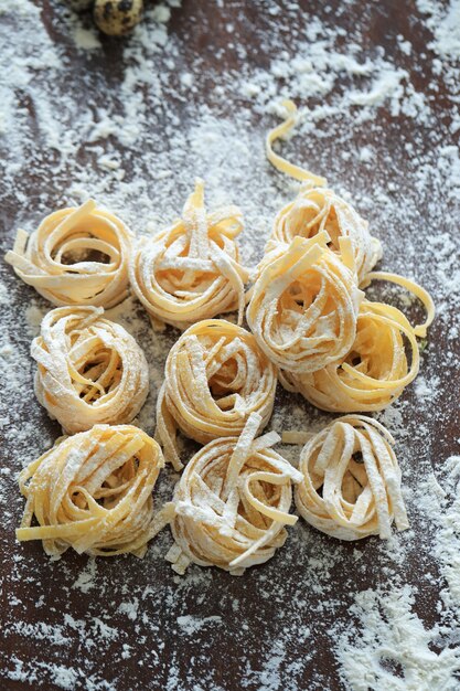 Closeup of process of making cooking homemade pasta.